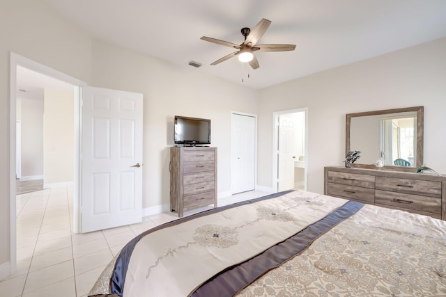 bedroom featuring connected bathroom, a closet, ceiling fan, and light tile patterned flooring