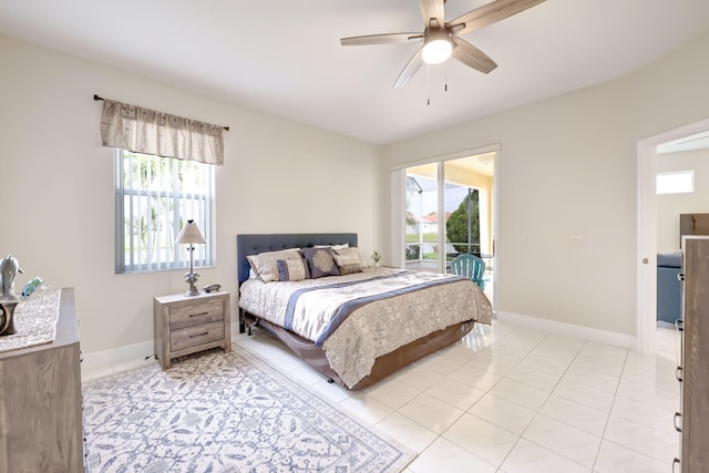 bedroom featuring light tile patterned floors, multiple windows, baseboards, and access to exterior