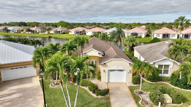 drone / aerial view with a water view and a residential view