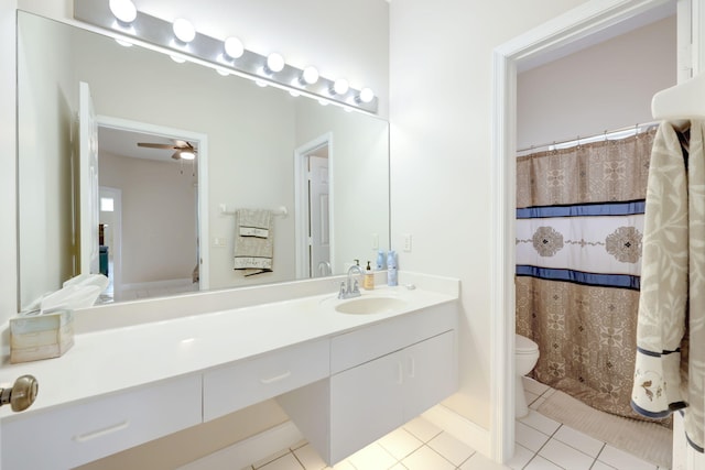 bathroom featuring ceiling fan, vanity, curtained shower, tile patterned floors, and toilet