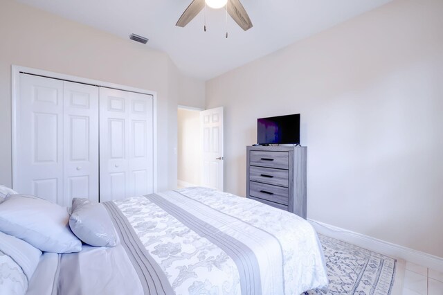 tiled bedroom featuring ceiling fan