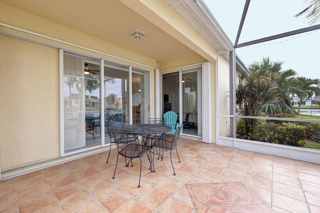 sunroom / solarium with a ceiling fan