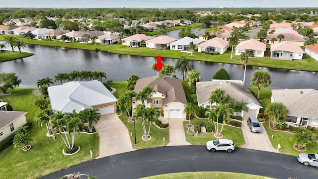 bird's eye view with a water view and a residential view