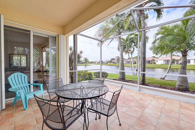 sunroom / solarium with a water view