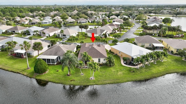 birds eye view of property featuring a water view and a residential view