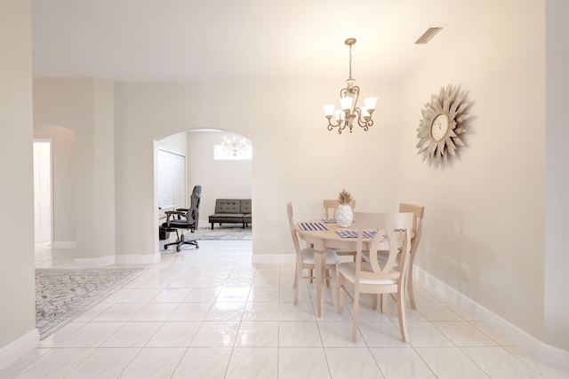 dining space with a chandelier and light tile patterned floors