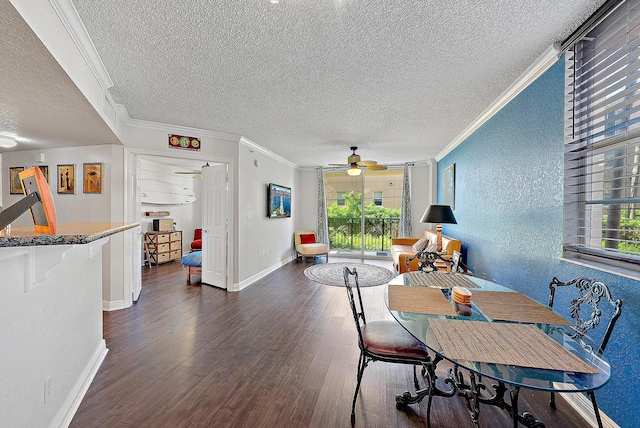 dining room with a textured ceiling, dark hardwood / wood-style flooring, ceiling fan, and ornamental molding