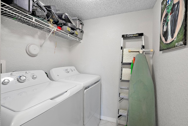 laundry room featuring tile patterned floors, a textured ceiling, and independent washer and dryer