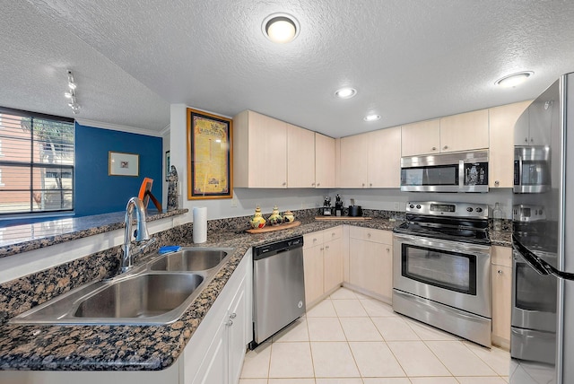 kitchen featuring kitchen peninsula, a textured ceiling, and appliances with stainless steel finishes