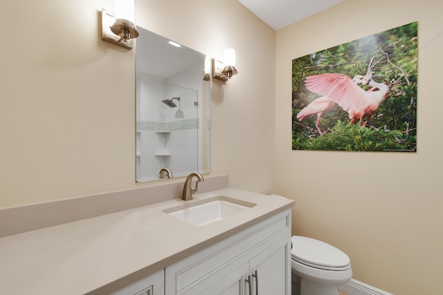 bathroom featuring walk in shower, vanity, and toilet