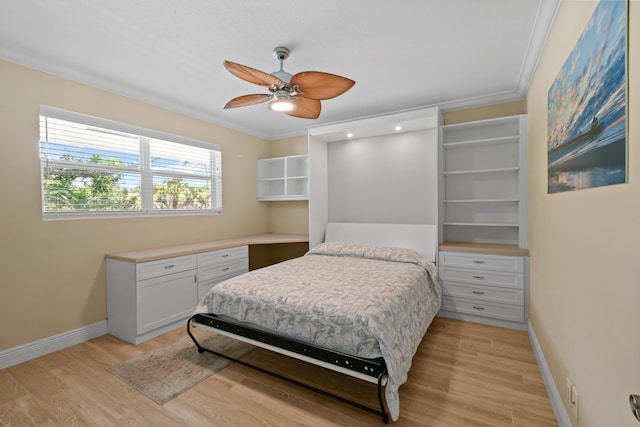 bedroom featuring light hardwood / wood-style floors, ceiling fan, and ornamental molding