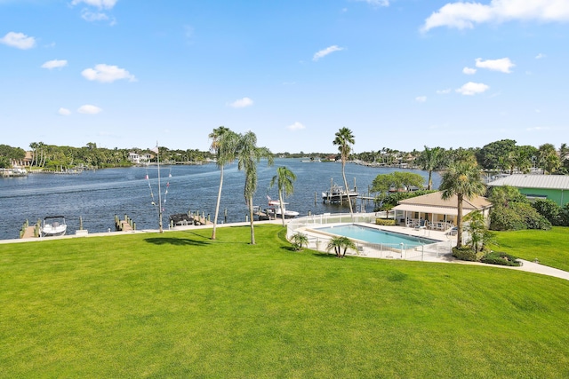 exterior space with a lawn, a water view, and a boat dock