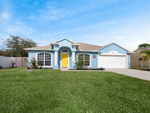 single story home featuring a front yard and a garage