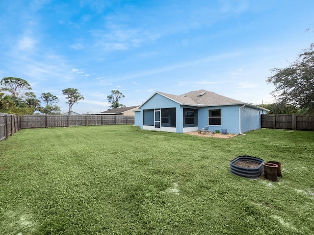 back of house with a lawn