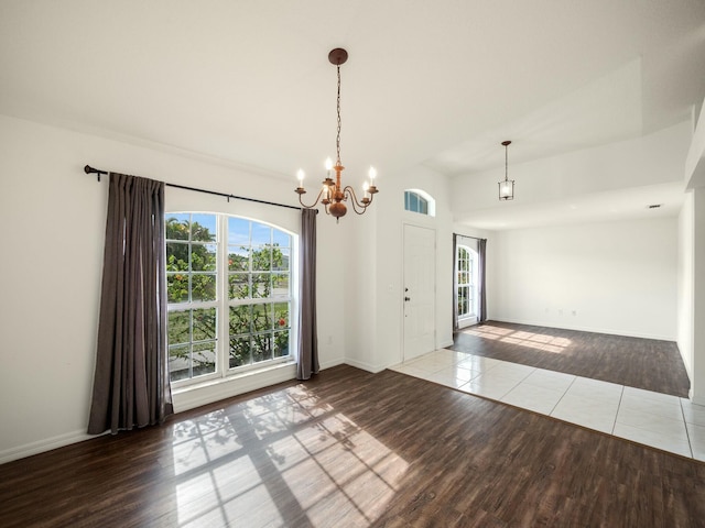 interior space featuring hardwood / wood-style flooring and an inviting chandelier