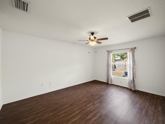 empty room with dark hardwood / wood-style floors and ceiling fan