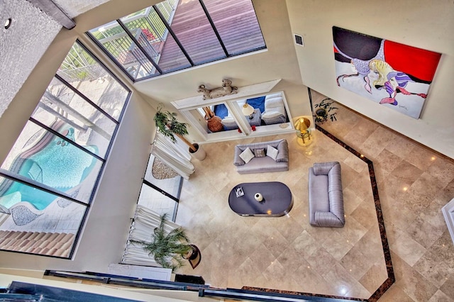 living room featuring a towering ceiling