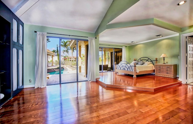 bedroom with wood-type flooring, access to outside, and vaulted ceiling