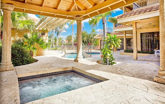 view of pool featuring a gazebo, a patio area, and an in ground hot tub