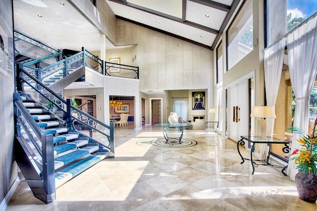 foyer with beamed ceiling and high vaulted ceiling