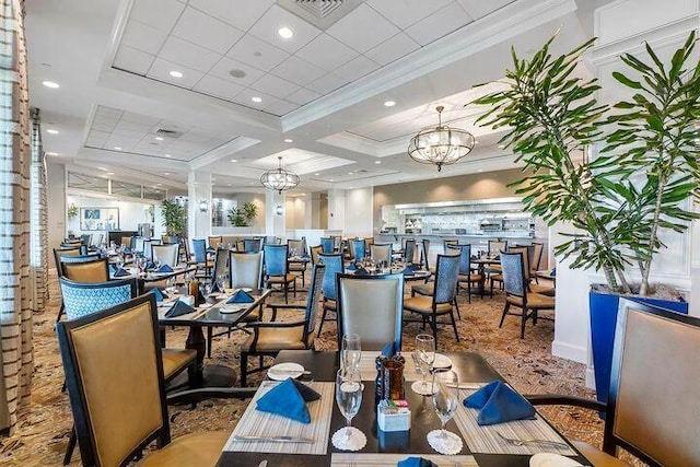 dining space with beam ceiling, crown molding, coffered ceiling, and a notable chandelier