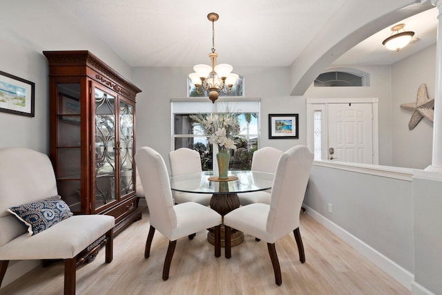 dining room featuring light hardwood / wood-style flooring and an inviting chandelier