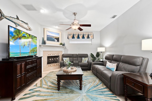 living room with a fireplace and ceiling fan