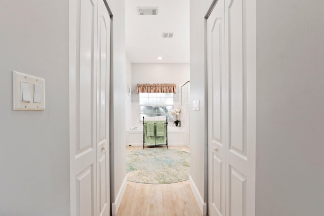 hallway with hardwood / wood-style flooring