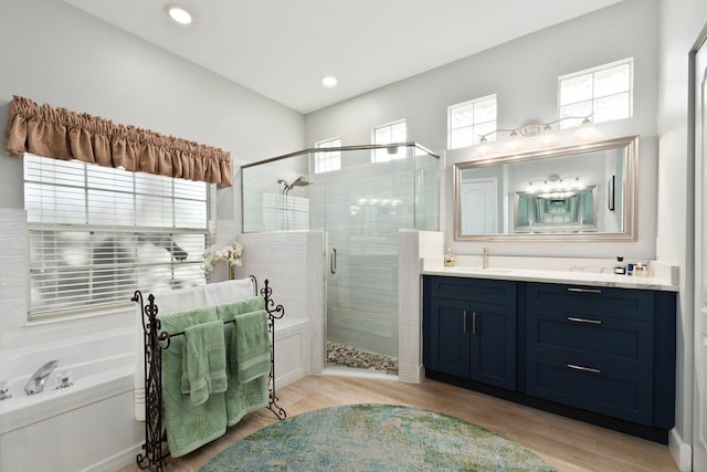 bathroom with vanity, plus walk in shower, and hardwood / wood-style flooring