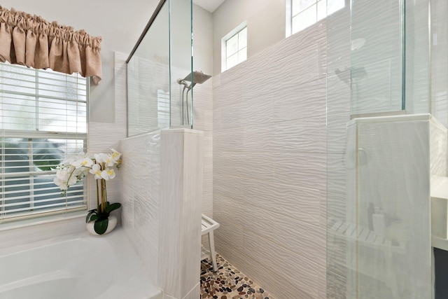 bathroom with independent shower and bath and tile walls