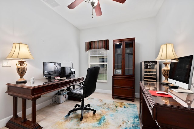 office with ceiling fan, light hardwood / wood-style flooring, and beverage cooler