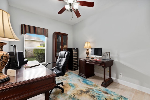 home office featuring ceiling fan and light hardwood / wood-style floors