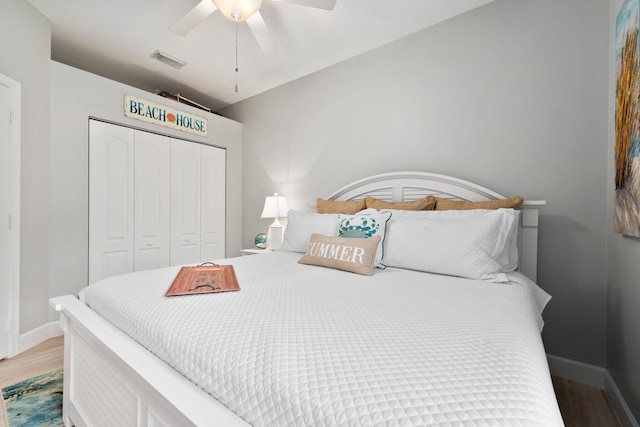 bedroom featuring wood-type flooring, a closet, and ceiling fan