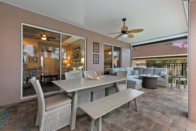 view of patio with outdoor lounge area and ceiling fan