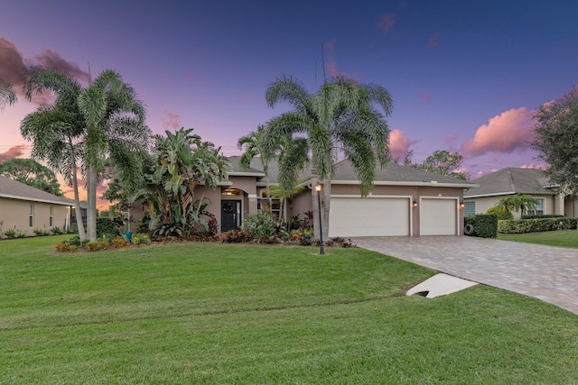 view of front of house featuring a lawn and a garage