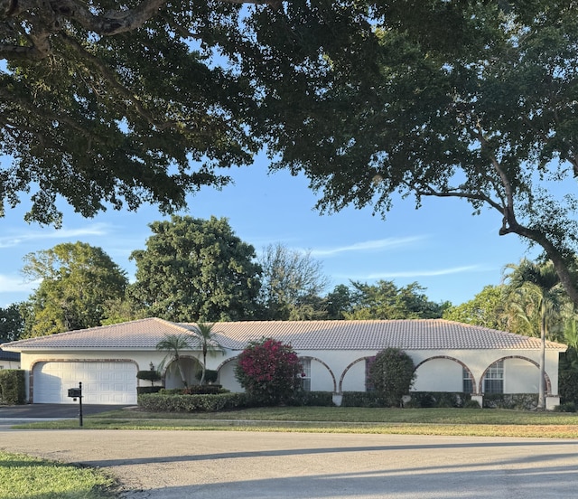 view of front of property with a garage and a front lawn