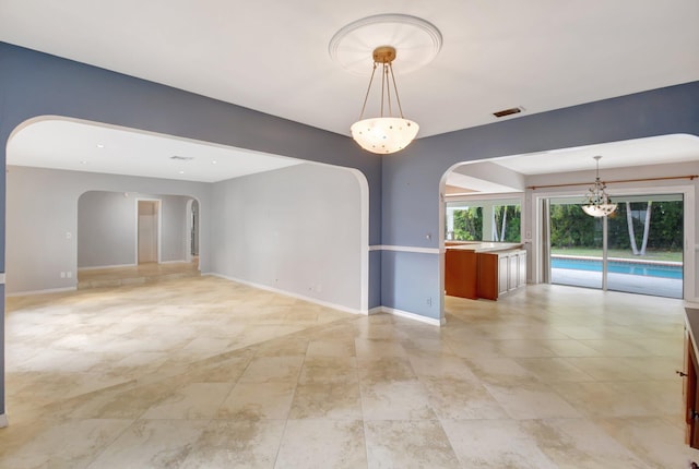 empty room with a notable chandelier