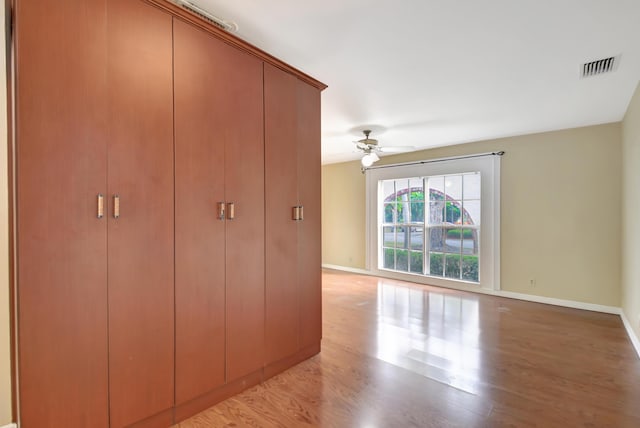 unfurnished bedroom with ceiling fan and light wood-type flooring