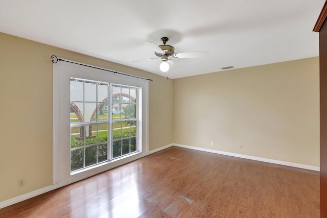 spare room with ceiling fan and wood-type flooring