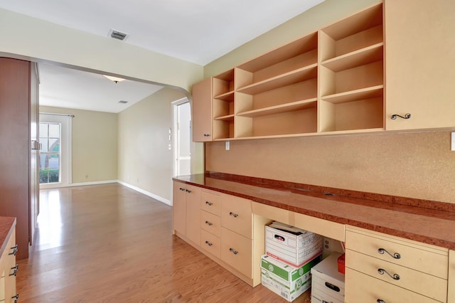 kitchen with cream cabinets and light wood-type flooring