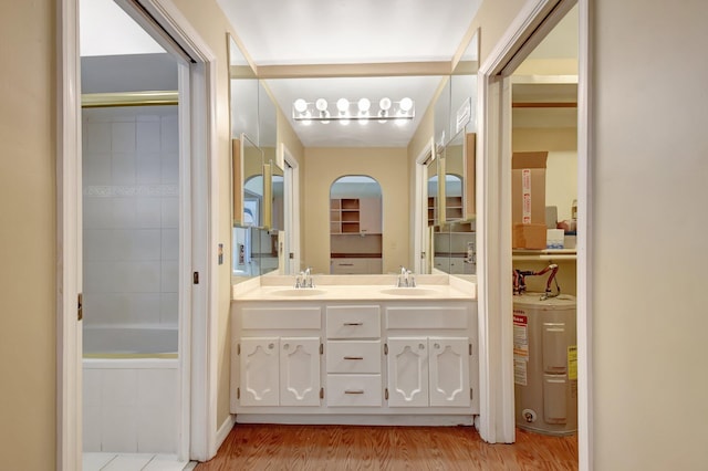 bathroom featuring vanity, wood-type flooring, and water heater