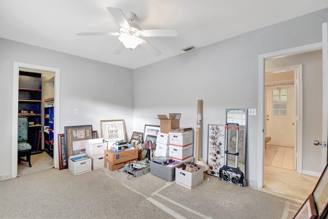 interior space with carpet flooring and ceiling fan