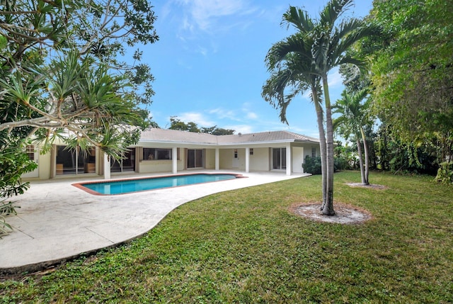 view of pool featuring a patio area and a yard