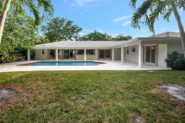 view of pool with a yard and a patio