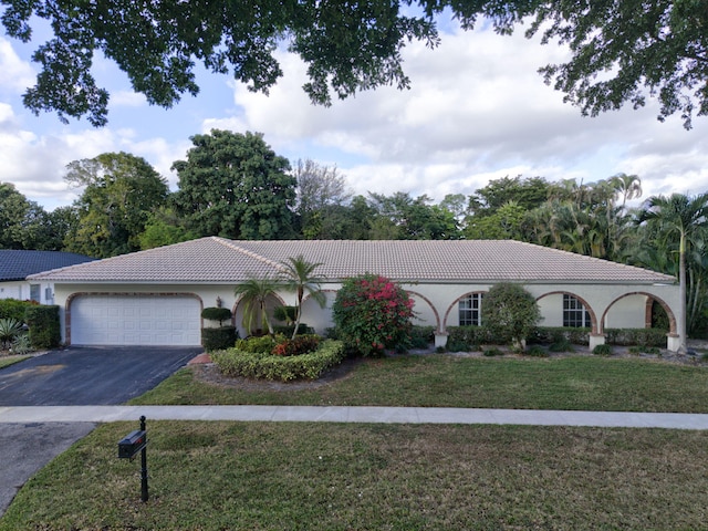 view of front of house with a front yard and a garage