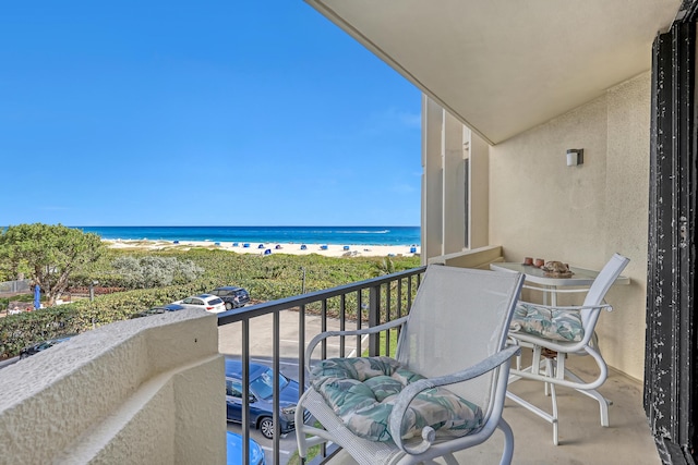 balcony with a beach view and a water view