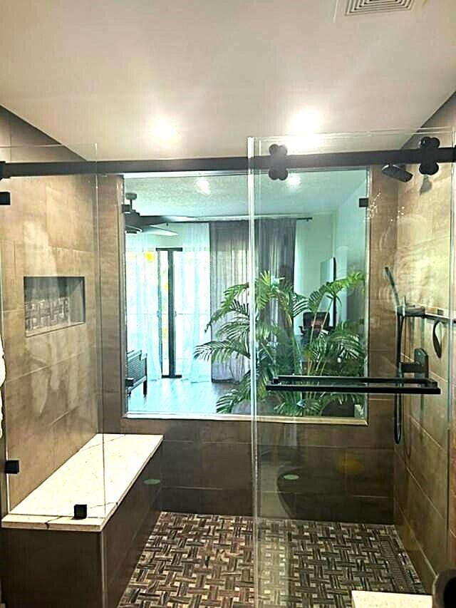 bathroom featuring a shower with door