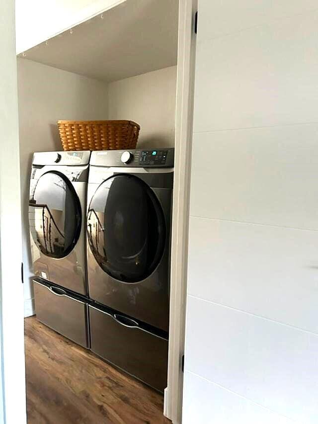 washroom featuring separate washer and dryer and dark wood-type flooring