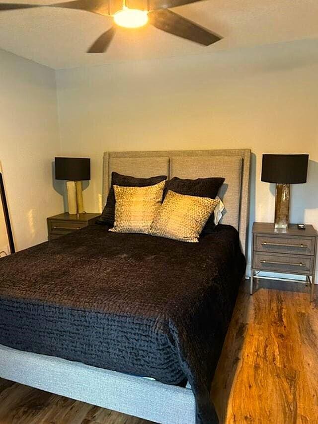 bedroom featuring ceiling fan and dark wood-type flooring