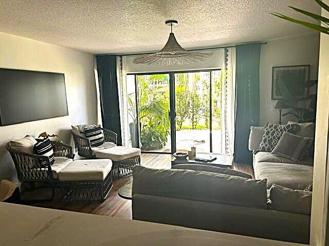 living room featuring hardwood / wood-style floors and a textured ceiling